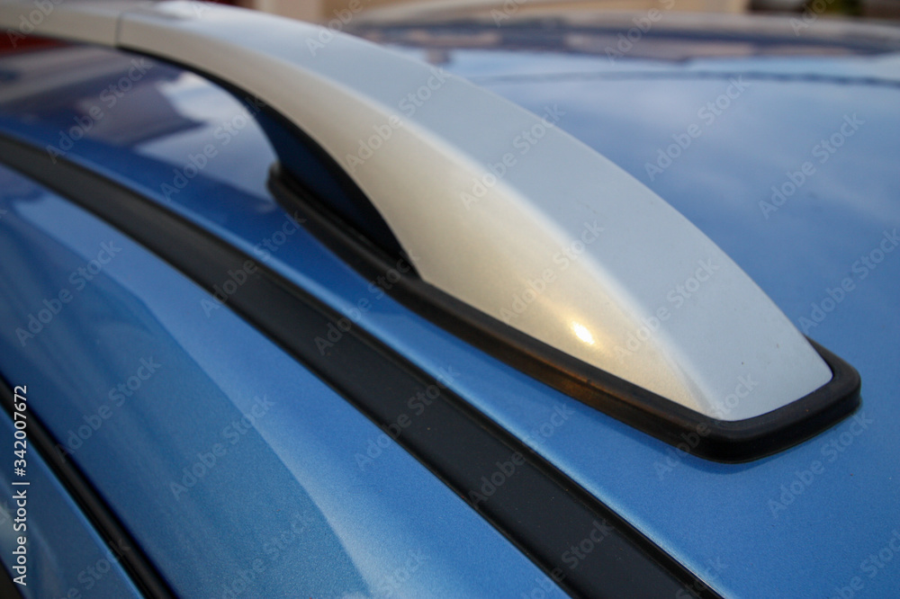 Silver roof rack on blue vehicle