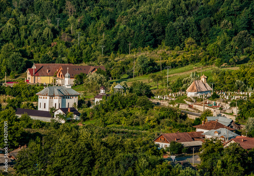 The new church, the old wooden church and the cemetery from Novaci-Români-view from the Ungurenilor plain photo