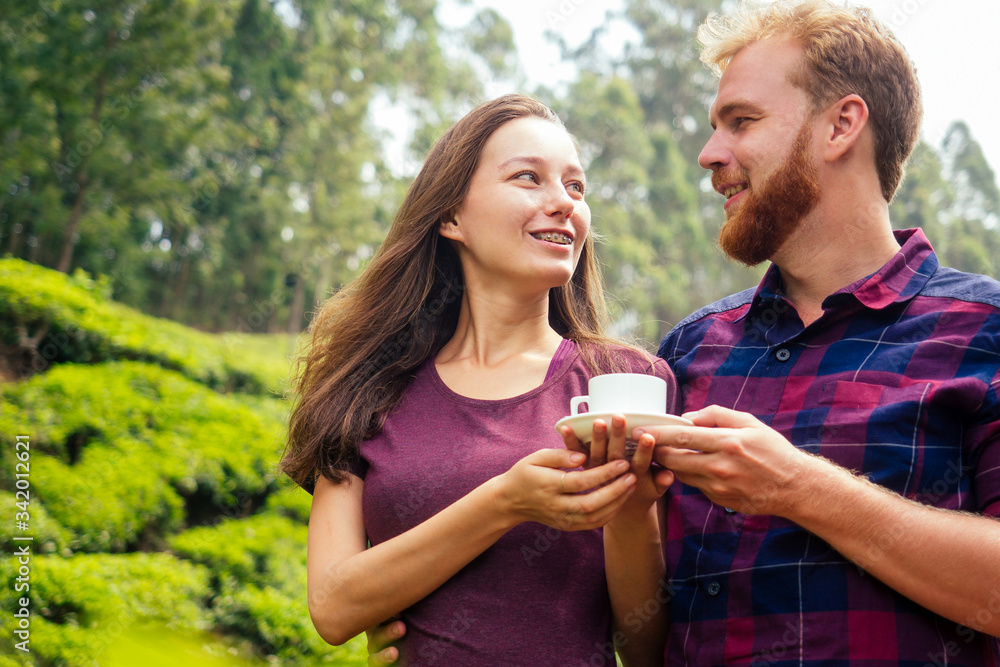Couple in love at tea plantation looking at eye each other and smiling in munnar kerala india Couple in love at tea plantation looking at eye each other and smiling in munnar kerala india