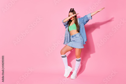 Full length photo of music lover girl enjoy dab dancer perform stage dance wear green denim clothes sneakers isolated over pastel color background