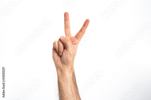 hand gesture of a male showing victory sign or number two