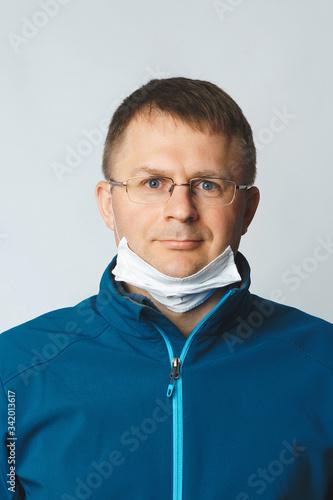 man with medical mask on chin