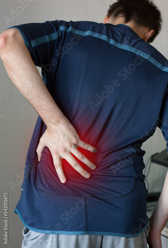 Man with back pain at home