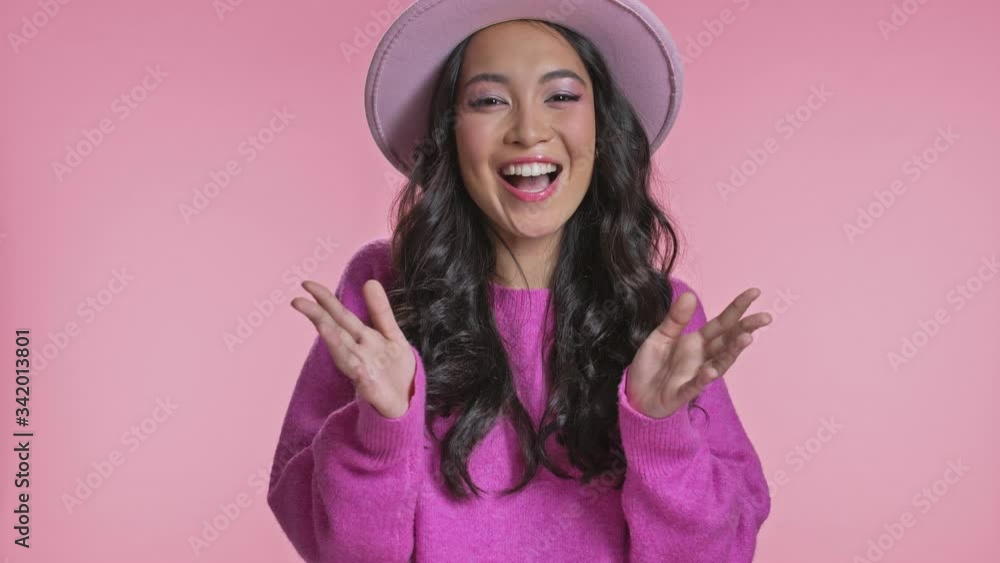 Amazing surprised young asian woman posing isolated over pink wall background. Amazing surprised young asian woman posing isolated over pink wall background.