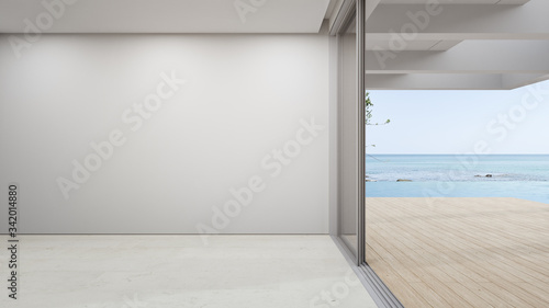 Blank wall on empty beige marble floor of large living room in modern house or luxury pool villa. Minimal home interior 3d rendering with beach and sea view.