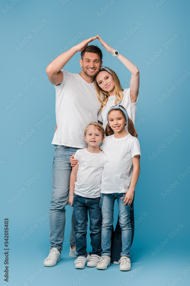 happy family with kids making roof gesture over heads on blue happy family with kids making roof gesture over heads on blue