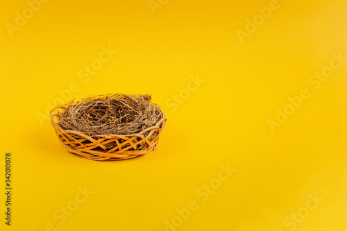 Nest on yellow background. Concept of easter postcard. Organic meat and egg on farm.