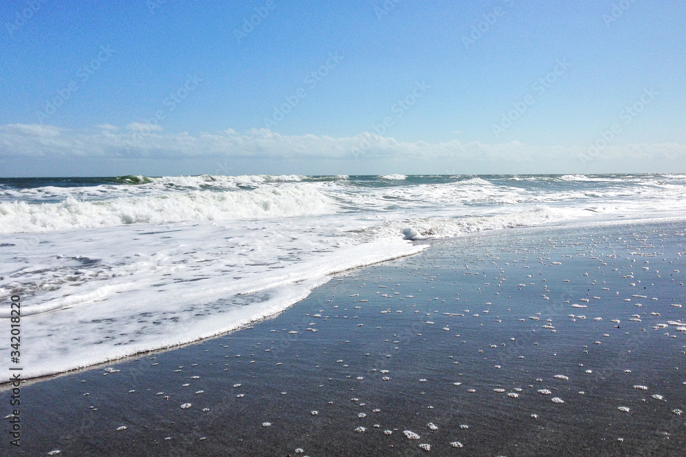 Cocoa Beach, Florida/USA - Nov 5, 2016: Picture of the sandy beach in Florida. Huge waves and dark sand on Cocoa Beach at sunny weather.