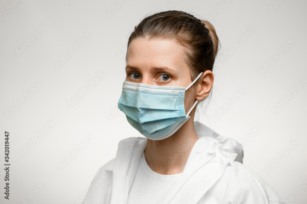 Young female nurse in medical mask which looking aside. Young female nurse in medical mask which looking aside.
