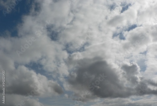 Beautiful blue sky with clouds background. Sky clouds. Air and fluffy clouds in the blue sky on a sunny day, background texture. Copy space for your text.