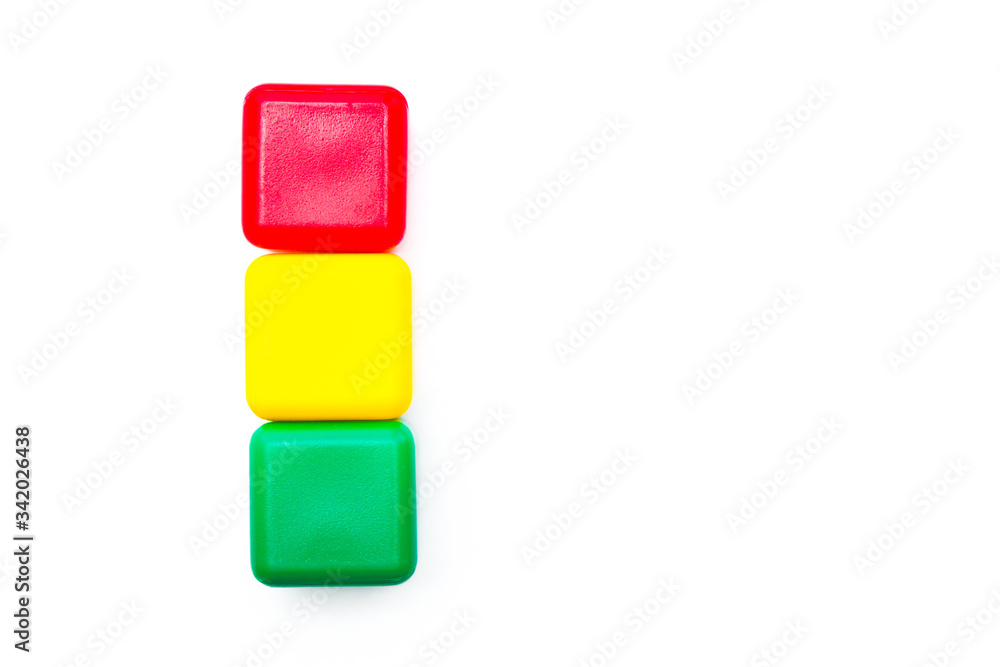Children toys. Multicolored cubes in a shape of traffic light on white background. Isolated Children toys. Multicolored cubes in a shape of traffic light on white background. Isolated