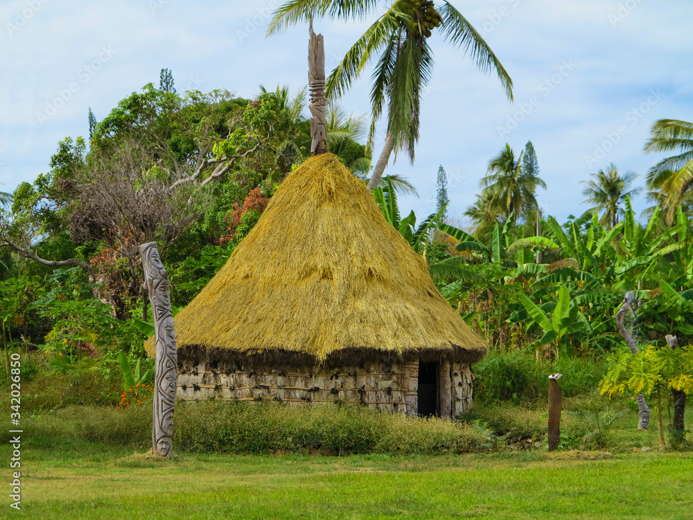 Typical Kanak house in New Caledonia with sculptures from the life of the local people. Typical Kanak house in New Caledonia with sculptures from the life of the local people.