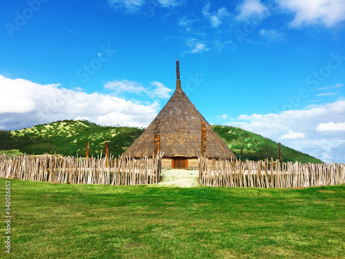 Typical Kanak house in New Caledonia with sculptures from the life of the local people.