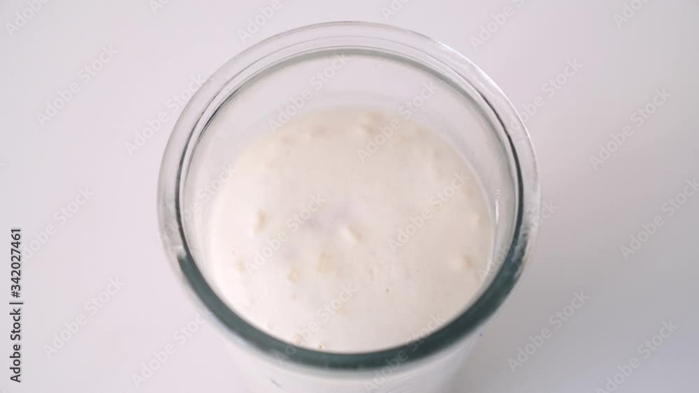 Dough starter (brew) made wheat flour, yeast and water and used for pizza, bread or all kind of yeast risen baked goods. Horizontal timelapse video of yeast dough starter rising up (fermenting) Dough starter (brew) made wheat flour, yeast and water and used for pizza, bread or all kind of yeast risen baked goods. Horizontal timelapse video of yeast dough starter rising up (fermenting)