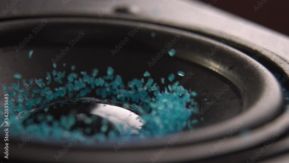 Trembling loudspeaker throwing blue flour in the air. Super slow motion close-up shot. Trembling loudspeaker throwing blue flour in the air. Super slow motion close-up shot.