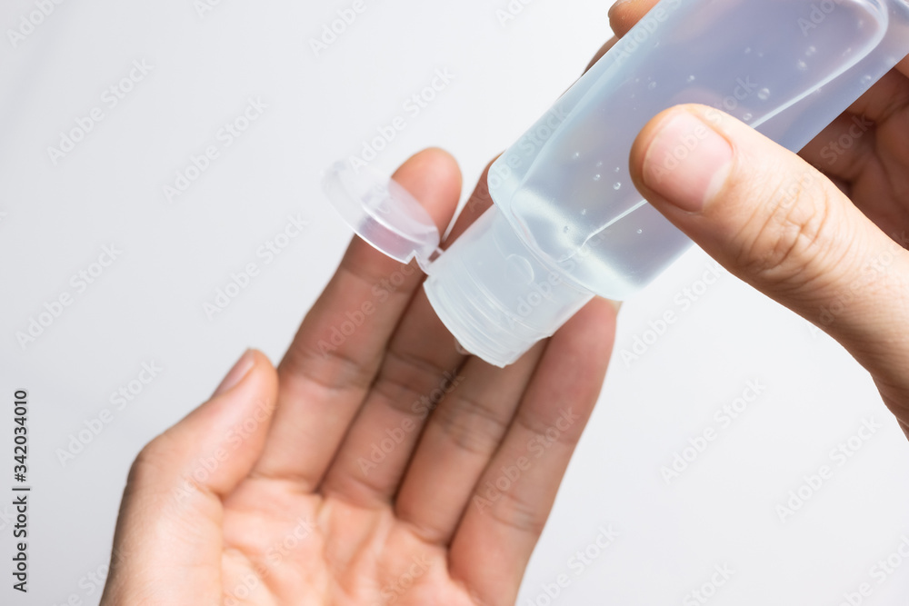 Man using alcohol gel, hand sanitizer gel for protection coronavirus disease (covid-19) and germ during work at home, health care concept (select focus) Man using alcohol gel, hand sanitizer gel for protection coronavirus disease (covid-19) and germ during work at home, health care concept (select focus)