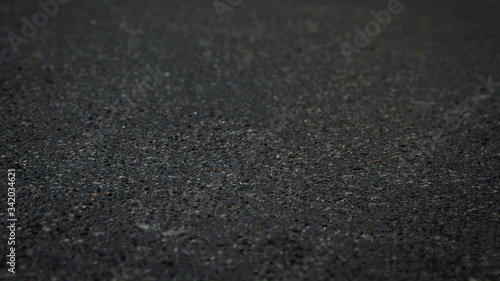 Abstract dark Tar Asphalt Background at an angle of 20 degrees. Black warm asphalt Soft focus.