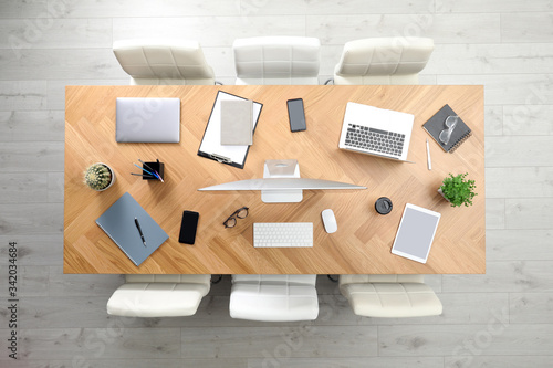 Modern office table with devices and chairs, top view