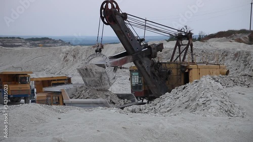 Heavy Mining Dump Truck Being Loaded With Iron Ore in pit