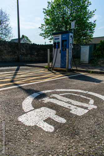 Spaces clearly allocated for the rapid EV electric car charging station installed in a small town free car park in the south west of England.