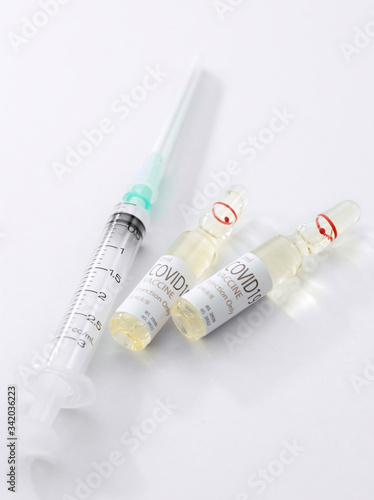 Close up view of the ampules with medicine and syringe on white back 