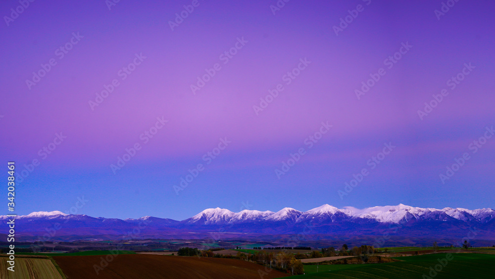 Panorama mountain view under wide pink sky