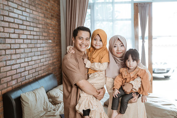 beautiful muslim family smiling to camera. ramadan concept at home