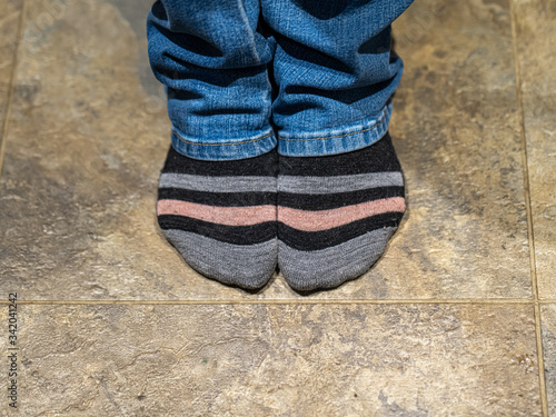 Woman's feet with colorful socks and bluejeans close-up