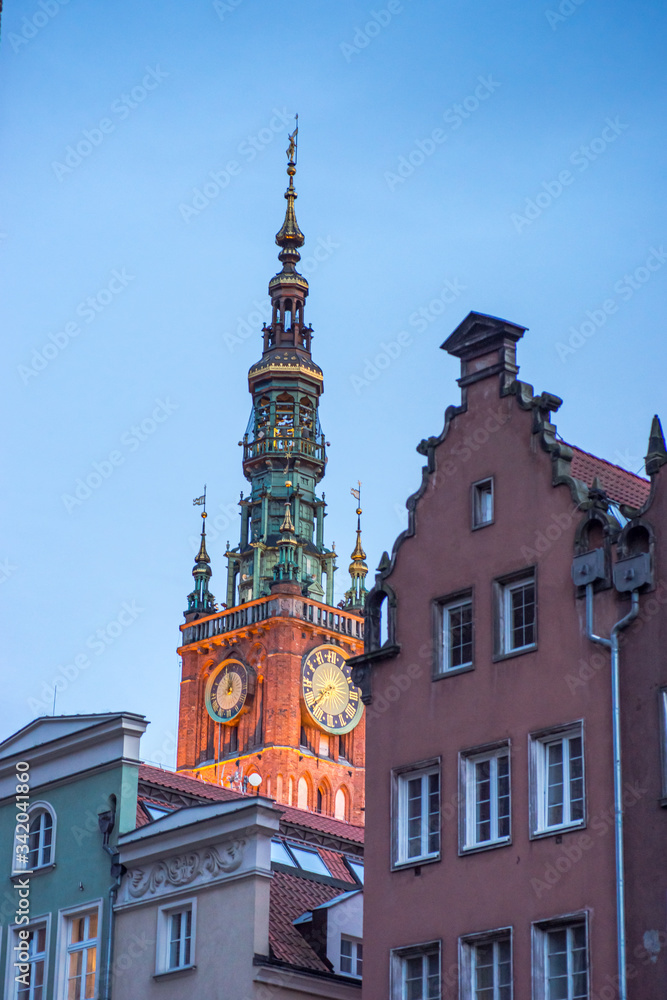 Obraz premium Spire of Gdansk Main Town Hall on background of summer cityscape, Poland 