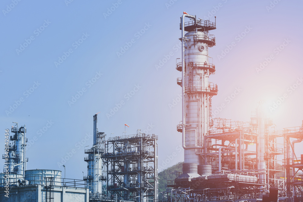 Oil and gas industrial, Oil refinery plant from industry, Refinery Oil storage tank and pipe line steel with blue sky with sunset.