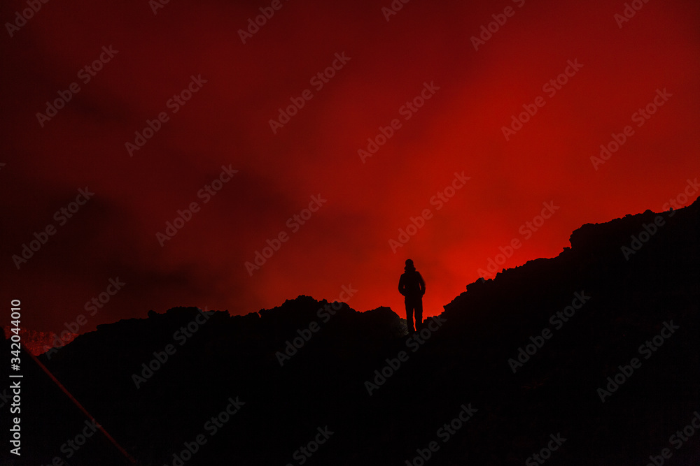 A tourist standing at the egde of the volcanic crater in Congo