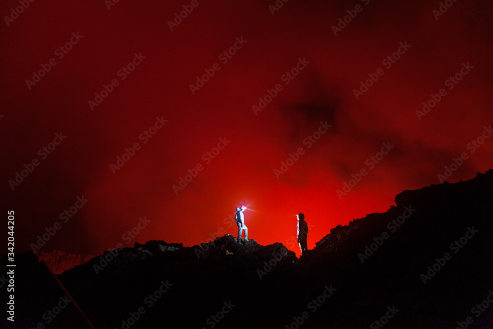 Democratic Republic of Congo - March 10, 2018. Tourists walking in front of the crater of Nyiragongo volcano