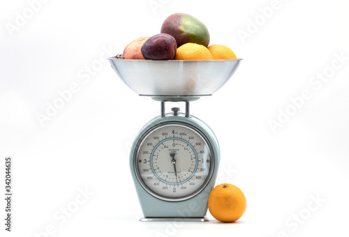 Slika na platnu fruit on kitchen food scale on white background