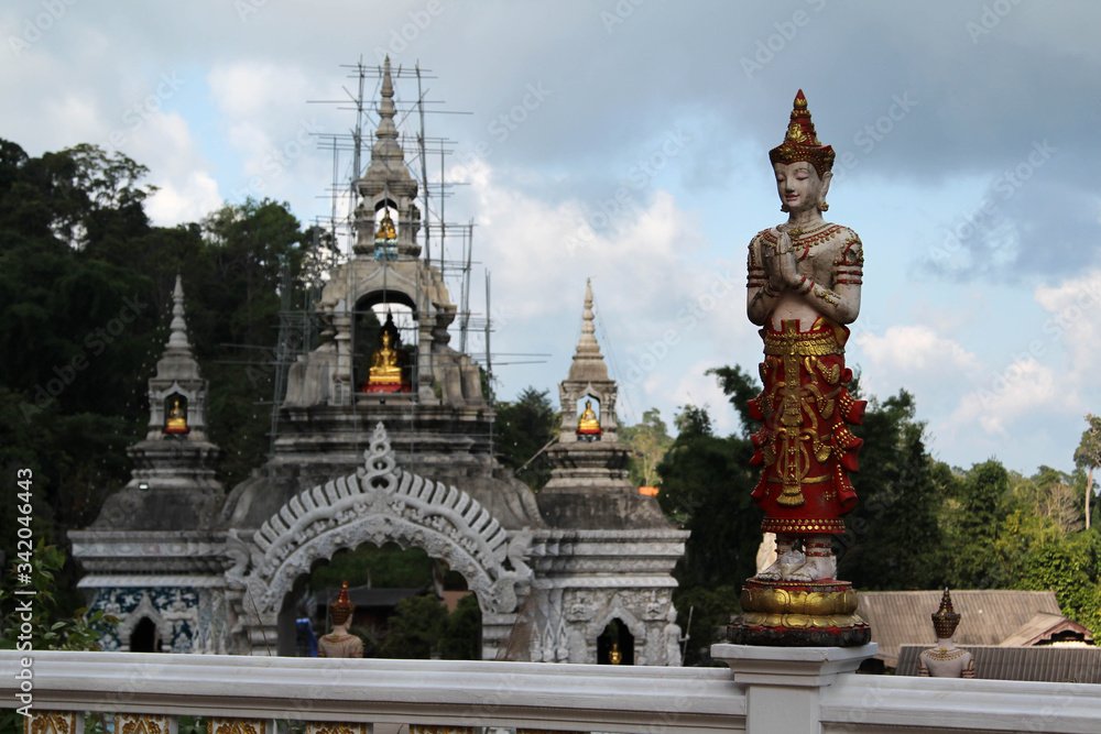Deva statue and entrance arch in Wat Phra Buddhabart Si Roy, Mae Rim District, Chiangmai province, Northern Thailand.