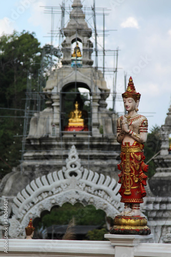Deva statue and entrance arch in Wat Phra Buddhabart Si Roy, Mae Rim District, Chiangmai province, Northern Thailand.
