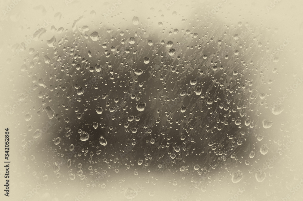 Drops of water on the misted glass. Toned photo, soft focus. Original vintage background with vignetting. Drops of water on the misted glass. Toned photo, soft focus. Original vintage background with vignetting.