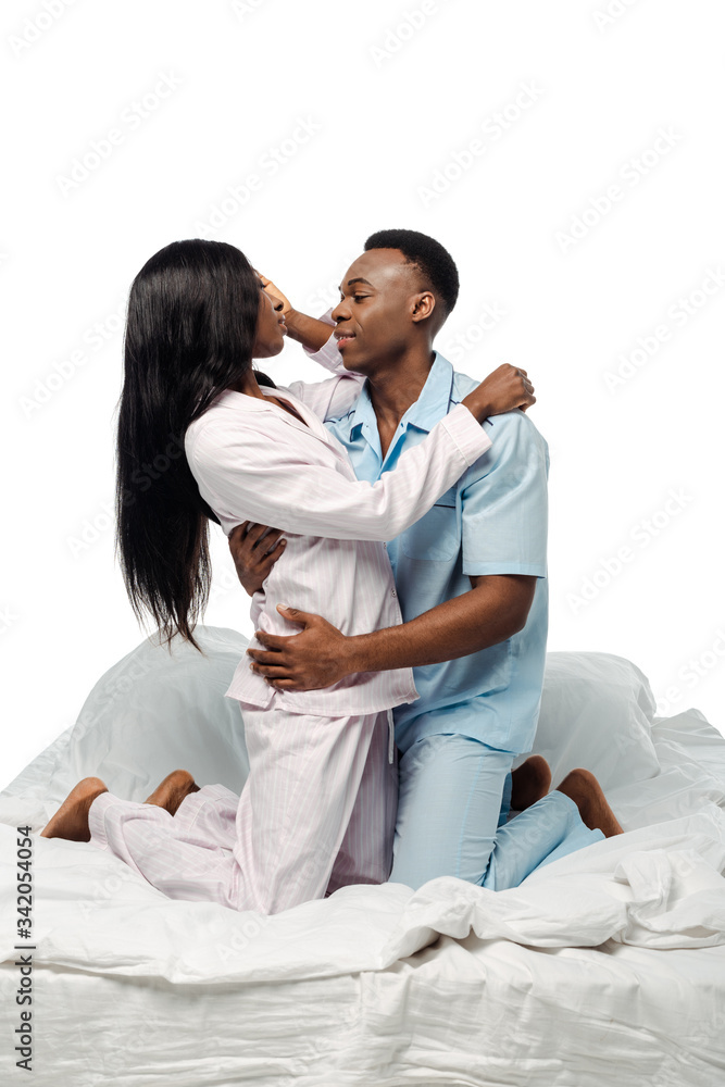 african american couple hugging in bed in pajamas isolated on white african american couple hugging in bed in pajamas isolated on white