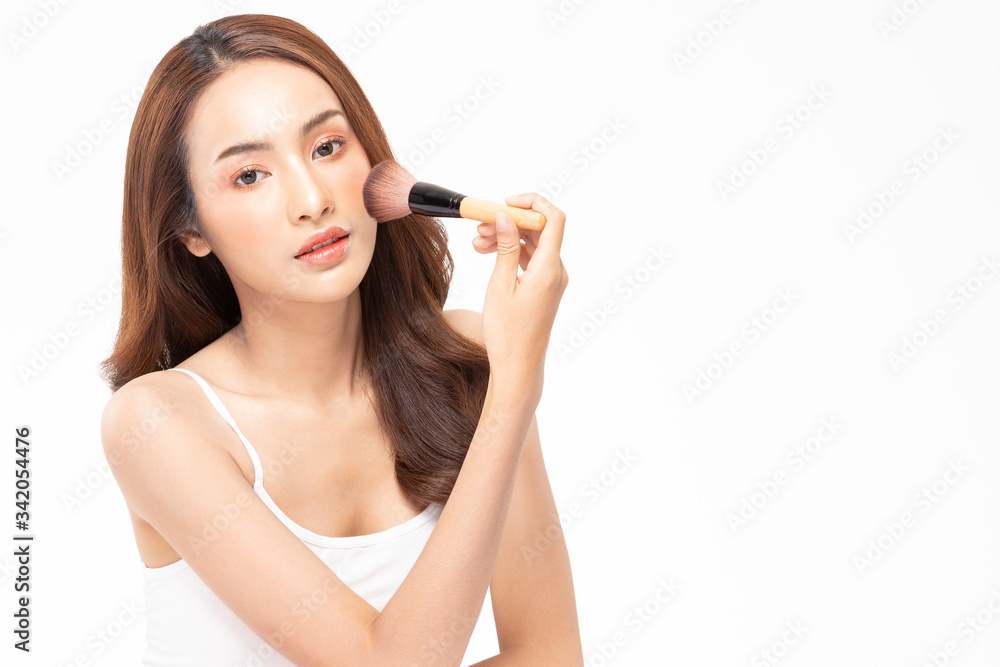 Obraz premium Beauty asian woman brown hair looking smile in camera happiness and hold make up brush and cheerful with make up brush,Beauty Concept on white background.