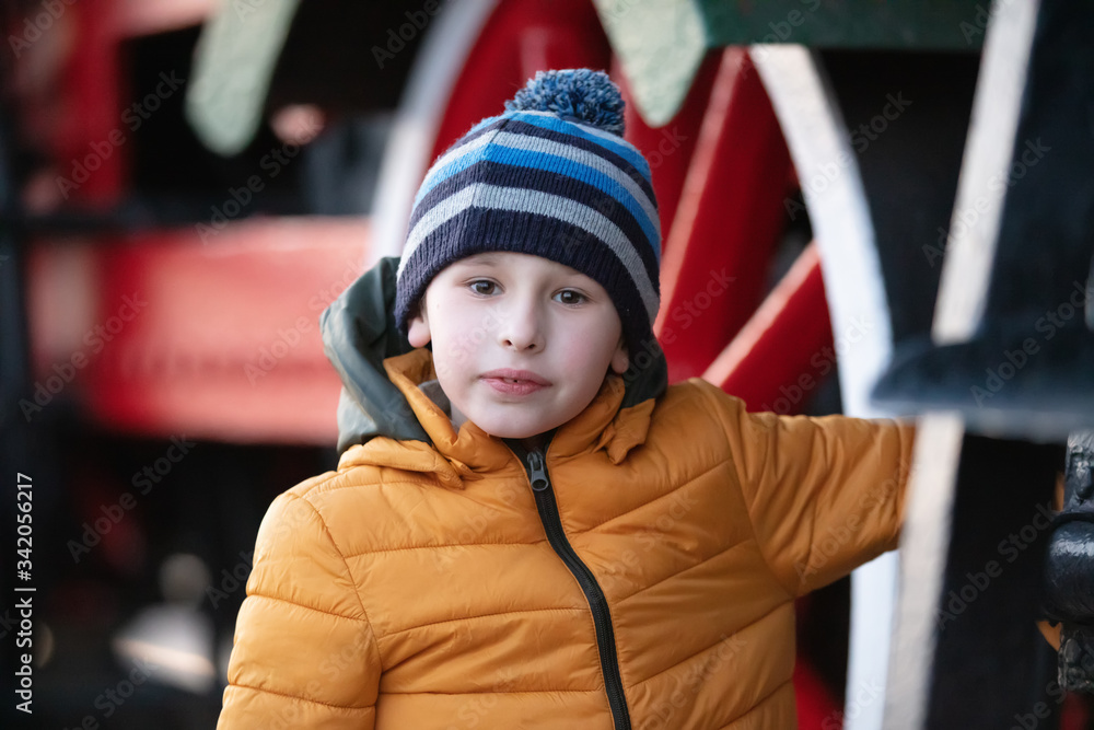 Portrait of an eight year old boy in a jacket and hat. Portrait of an eight year old boy in a jacket and hat.