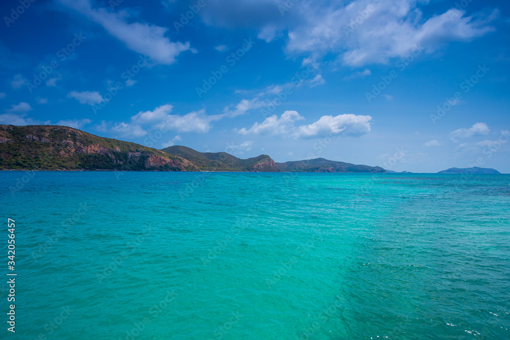 Fototapeta premium Phi Phi Lay island with tall cliffs and mountains, blue shy and white clouds ,Clear water and mountains,crystal clear Adriatic Sea and Blue Sky with White Clouds