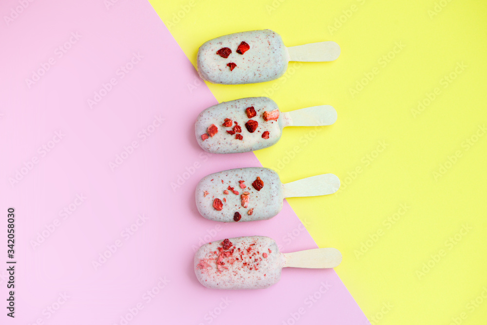 Eskimo ice cream in white chocolate glaze with red sprinkles on pink background. Yummy sweet food snack treat. Top view. Eskimo ice cream in white chocolate glaze with red sprinkles on pink background. Yummy sweet food snack treat. Top view.