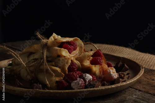 delicious pancakes on a black background in rustic style