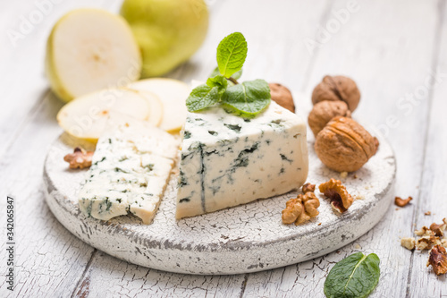 Photos Segment of blue mould cheese - Gorgonzola with pear and walnuts on wooden board