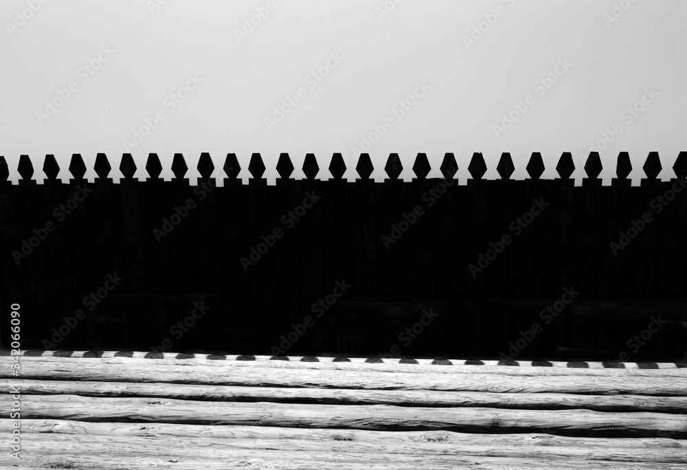 an ancient wooden fence and wall made of folded and chopped logs an ancient wooden fence and wall made of folded and chopped logs