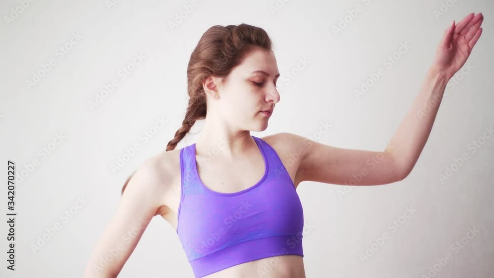 Engage in sports online at home isolation. Stretching exercises, training of muscles of the back on a white background Engage in sports online at home isolation. Stretching exercises, training of muscles of the back on a white background
