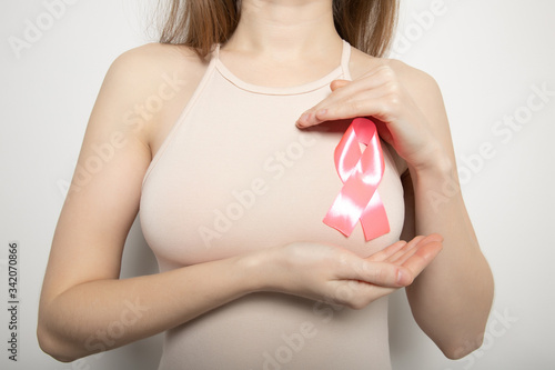 Wallpaper Mural The symbol of the fight against breast cancer. Pink ribbon on the girl’s chest. Torontodigital.ca