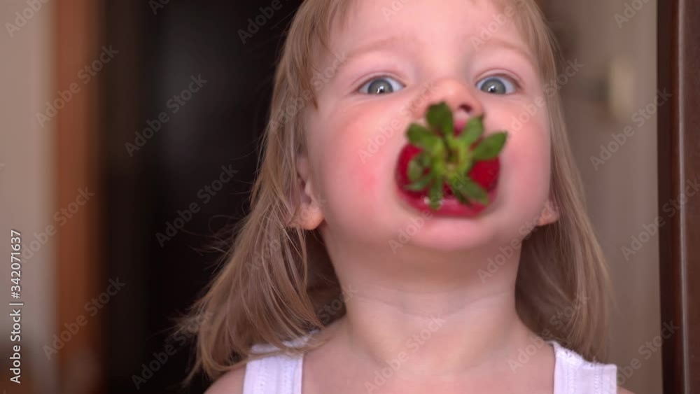 the child eats strawberries. fresh berries are very useful for children the child eats strawberries. fresh berries are very useful for children