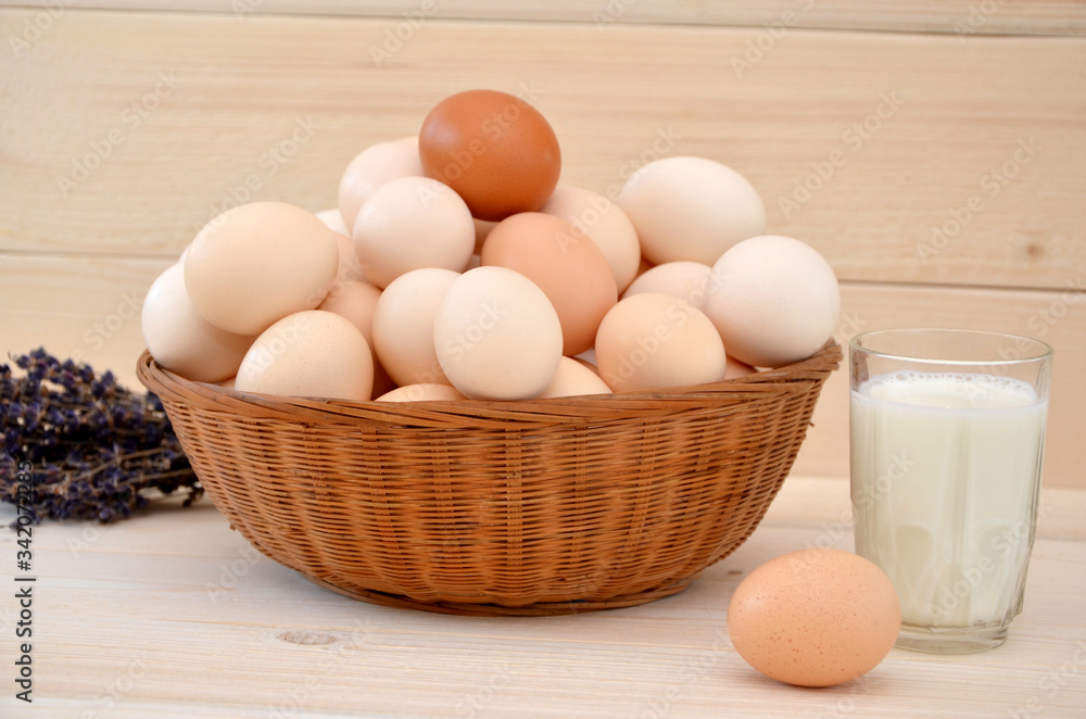 rustic still life basket with eggs and glass of milk on wooden background rustic still life basket with eggs and glass of milk on wooden background