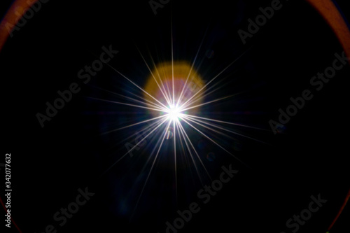 Flare wallpaper. Star spot or sun shine glow light on lens. Sunlight ray flash effect on black background. Optical leaking reflection and abstract bokeh lights.