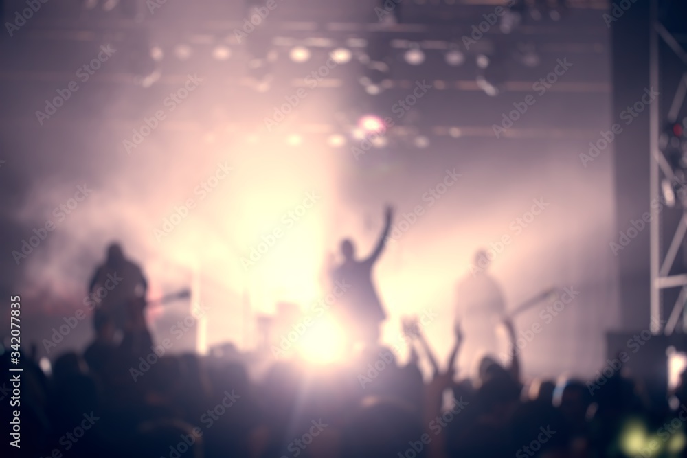 Blurred scene of a concert with light lit stage